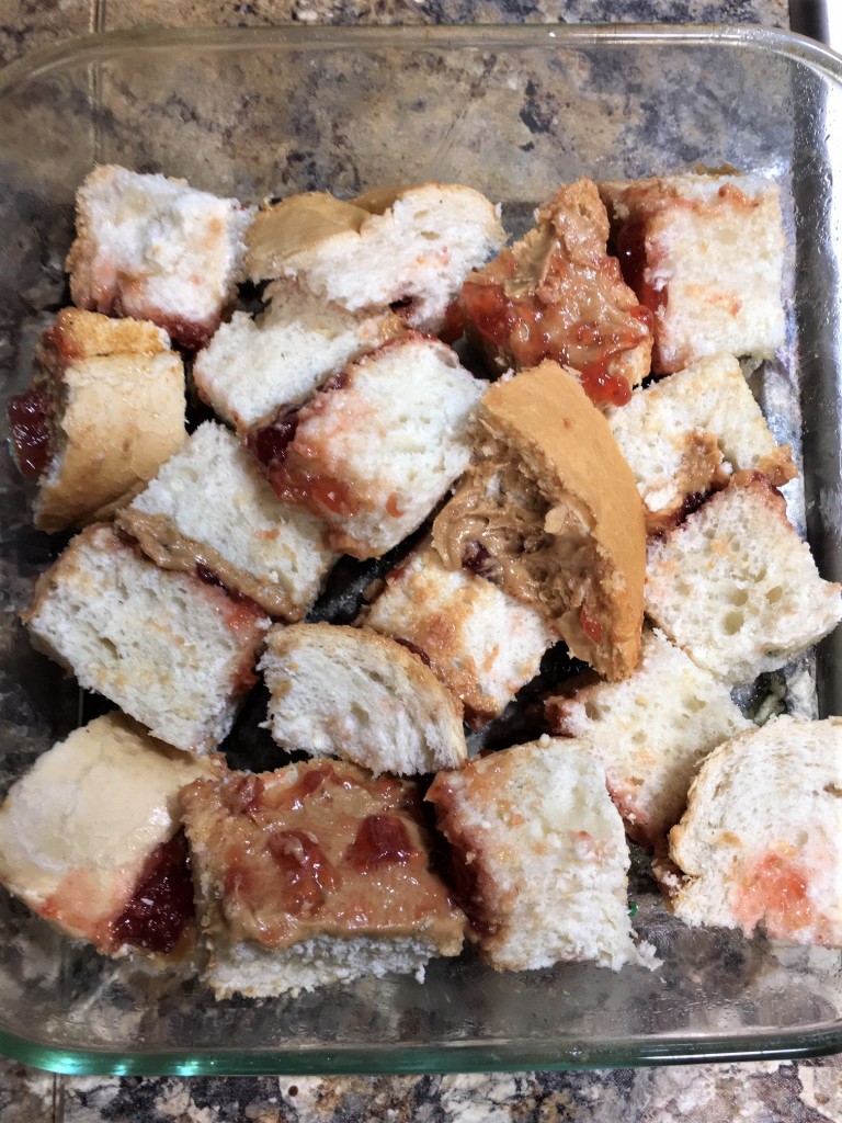 Peanut Butter and Jelly Bread Pudding made with sourdough bread and homemade custard. Gobs of peanut butter and strawberry jam. PB&J never tasted this good!